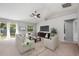 Bright living room with neutral color scheme, ceiling fan, and ample natural light at 304 Woods Landing Dr, Lady Lake, FL 32159