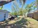 An ample backyard featuring a mix of greenery and potential for customization, bordered by a wooden fence for privacy at 307 S Hiawassee Rd, Orlando, FL 32835
