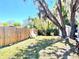 A spacious fenced backyard with mature trees providing plenty of shade and a shed for extra storage at 307 S Hiawassee Rd, Orlando, FL 32835