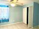 Comfortable bedroom featuring a ceiling fan, tile flooring, and a large closet at 307 S Hiawassee Rd, Orlando, FL 32835
