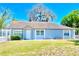 Charming single story home featuring a well manicured lawn and a white picket fence at 307 S Hiawassee Rd, Orlando, FL 32835