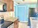 Efficient kitchen featuring stainless steel appliances, granite countertops, and tiled flooring at 307 S Hiawassee Rd, Orlando, FL 32835