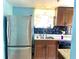 Functional kitchen featuring stainless steel refrigerator, granite countertops, and black backsplash at 307 S Hiawassee Rd, Orlando, FL 32835