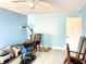 A light blue living room with tile floors and a ceiling fan, ready to be furnished to your liking and enjoy relaxing at 307 S Hiawassee Rd, Orlando, FL 32835