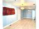 Bright living room featuring tile flooring, light-blue walls, and modern lighting fixtures at 307 S Hiawassee Rd, Orlando, FL 32835