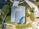 An overhead view of the home and screened-in pool showcasing lush landscaping and neighborhood at 3469 Foxton Ct, Oviedo, FL 32765
