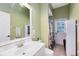 Charming bathroom featuring a single sink vanity, tiled floors, and a shower with a curtain at 3469 Foxton Ct, Oviedo, FL 32765