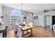 Bright dining room with a large window, modern lighting, and elegant table setting at 3469 Foxton Ct, Oviedo, FL 32765