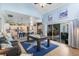 Open-concept living space with a pool table, leading to a modern kitchen and a bright dining area at 3469 Foxton Ct, Oviedo, FL 32765