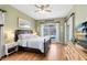 Serene main bedroom with hardwood floors, large windows, and views of the pool at 3469 Foxton Ct, Oviedo, FL 32765