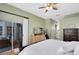 Comfortable bedroom with sliding glass door to the patio, hardwood floors, and a spacious layout at 3469 Foxton Ct, Oviedo, FL 32765