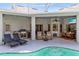 Outdoor kitchen area with a grill, sink, and dining area near the pool at 3469 Foxton Ct, Oviedo, FL 32765