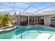 Backyard pool featuring an outdoor kitchen, lounge chairs, and jacuzzi at 3469 Foxton Ct, Oviedo, FL 32765