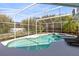 Backyard pool with screened-in enclosure and lush landscaping at 3469 Foxton Ct, Oviedo, FL 32765