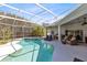Beautiful screened-in pool with a lounge area and an outdoor kitchen at 3469 Foxton Ct, Oviedo, FL 32765