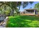 Expansive backyard leading to river, featuring a covered outdoor living space and dock at 3655 E Osceola Rd, Geneva, FL 32732