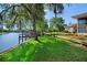 Lawn stretches out to a river view and features a covered wooden dock at 3655 E Osceola Rd, Geneva, FL 32732