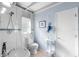 Cozy, colorful bathroom featuring white fixtures, a light blue wall and walk-in shower at 3655 E Osceola Rd, Geneva, FL 32732