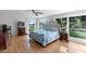 Bright bedroom featuring hardwood floors, a large window with scenic views, and an ensuite bathroom at 3655 E Osceola Rd, Geneva, FL 32732