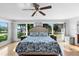 Bedroom with hardwood floors, a large window with scenic views, and two bedside tables and lamps at 3655 E Osceola Rd, Geneva, FL 32732