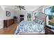 Bedroom with large windows overlooking the backyard featuring hardwood floors, a large window with scenic views at 3655 E Osceola Rd, Geneva, FL 32732