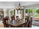 Dining room with wood table, chandelier, and natural light, perfect for Gathering meals and entertaining at 3655 E Osceola Rd, Geneva, FL 32732