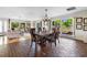 Bright dining area features wood table, plenty of seating, and large windows, creating a perfect space at 3655 E Osceola Rd, Geneva, FL 32732