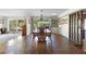 Spacious dining room featuring a large wooden table, brick floors, and natural light from surrounding windows at 3655 E Osceola Rd, Geneva, FL 32732