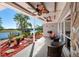 Covered patio with waterfront views, ceiling fans and comfortable seating at 3655 E Osceola Rd, Geneva, FL 32732