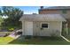 Exterior view of storage shed featuring neutral paint, shingled roof and well maintained landscaping at 3655 E Osceola Rd, Geneva, FL 32732