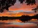 Picturesque sunset view reflecting on calm waters, framed by lush greenery and vibrant skies at 3655 E Osceola Rd, Geneva, FL 32732