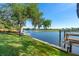Beautiful waterfront property features lush green lawn, mature trees and private dock at 3655 E Osceola Rd, Geneva, FL 32732