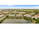 Stunning aerial view of the residential buildings showing the complex's community pool, lake and surrounding landscape at 4114 Breakview Dr # 11002, Orlando, FL 32819