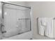 Modern bathroom with shower-tub combo, sliding glass door, and elegant white towels at 4114 Breakview Dr # 11002, Orlando, FL 32819