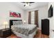 Comfortable bedroom with a queen-sized bed, ceiling fan, and wood flooring at 4114 Breakview Dr # 11002, Orlando, FL 32819