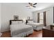 Comfortable bedroom with two beds, ceiling fan, and wood-look floors at 4114 Breakview Dr # 11002, Orlando, FL 32819