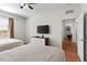 Comfortable bedroom with two beds, ceiling fan, wood-look floors, and wall-mounted TV at 4114 Breakview Dr # 11002, Orlando, FL 32819