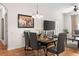Well-lit dining room featuring seating for six, wood floors and an elegant chandelier at 4114 Breakview Dr # 11002, Orlando, FL 32819