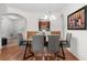 Dining room with seating for six, hardwood floors, and open concept to the kitchen at 4114 Breakview Dr # 11002, Orlando, FL 32819