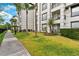 Exterior view of the property with sidewalks, tropical foliage, and well-manicured lawns at 4114 Breakview Dr # 11002, Orlando, FL 32819