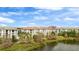Scenic view of white apartment buildings featuring lush landscaping and lakefront access at 4114 Breakview Dr # 11002, Orlando, FL 32819