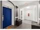 Condo hallway with a blue door, neutral walls, and modern decor, providing a clean and inviting entry space at 4114 Breakview Dr # 11002, Orlando, FL 32819