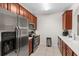 Modern condo kitchen featuring stainless steel appliances, wooden cabinets, and a bright countertop, perfect for cooking at 4114 Breakview Dr # 11002, Orlando, FL 32819