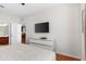 Primary bedroom with wood floors, a flat screen TV and ensuite bath access at 4114 Breakview Dr # 11002, Orlando, FL 32819