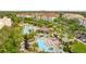 Aerial view of a luxurious community pool area surrounded by lush landscaping and lounge chairs at 4114 Breakview Dr # 11002, Orlando, FL 32819
