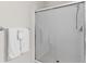 Modern walk-in shower with white tile, glass doors, and chrome fixtures at 4114 Breakview Dr # 11002, Orlando, FL 32819