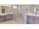 Elegant bathroom featuring double vanity sinks, a large walk-in shower, and modern fixtures at 4147 Coral Harbour Rd, Kissimmee, FL 34758