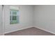 Neutral bedroom with carpet, white trim, and a bright window offering natural light at 4147 Coral Harbour Rd, Kissimmee, FL 34758