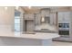 Modern kitchen boasts stainless steel appliances, ample counter space, and stylish gray cabinetry at 4147 Coral Harbour Rd, Kissimmee, FL 34758