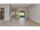 Bright and open living space with sliding glass doors and tile flooring leading into the kitchen at 4147 Coral Harbour Rd, Kissimmee, FL 34758